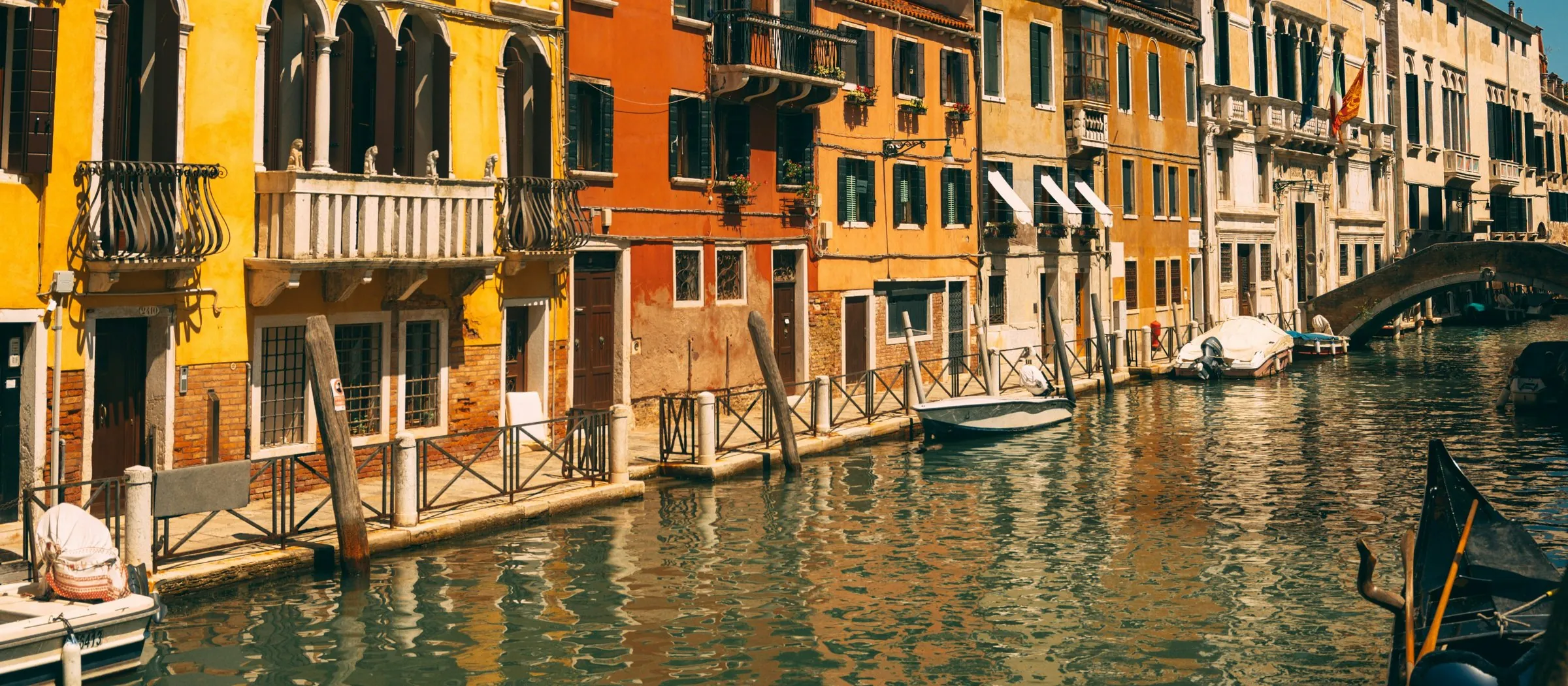 Ochre and terracotta palazzi reflected in a quiet Venetian canal.
